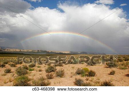 Stock Photo - A rainbow over the desert just outside Zion National Park, Utah, USA.. Fotosearch