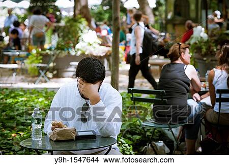 A reader uses his e-reader in Bryant Park in New York View Large Photo Image Picture - A reader uses his e-reader in Bryant Park in New York. Fotosearch