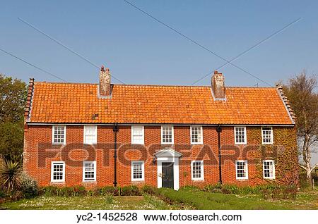 Stock Photo - A red brick house at Walberswick in Suffolk, England, Britain, Uk. Fotosearch