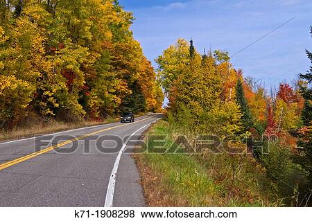 A road through the colorful deciduous forests of northern Minnesota in the autumn season View Large Photo Image Stock Photo - A road through the colorful deciduous forests of northern Minnesota in the autumn season. Fotosearch