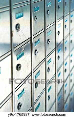 A row of small metal mailboxes with teal number tags View Large Photo Image Stock Photo - A row of small metal mailboxes with teal number tags. Fotosearch