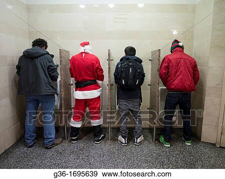 A Santa Claus and man with elf hat pee in urinals next to civilians during Santa Con, an annual pub crawl with thousands dressed as Santa Claus, in New York, New York, United States View Large Photo Image Stock Photo - A Santa Claus and man with elf hat pee in urinals next to civilians during Santa Con, an annual pub crawl with thousands dressed as Santa Claus, in New York, New York, United States. Fotosearch