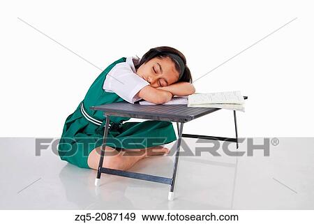 A schoolgril tired with studies fall asleep, Pune, India. View Large Photo Image Stock Photo - A schoolgril tired with studies fall asleep, Pune, India.. Fotosearch