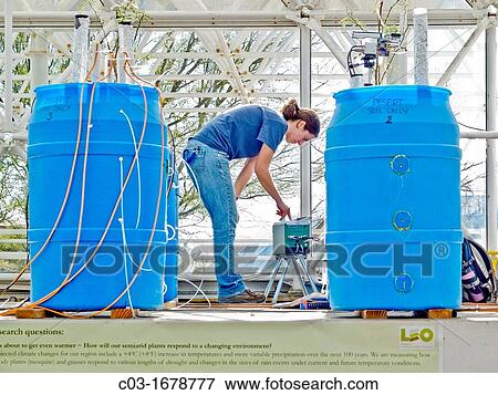 A scientist in the Landscape Evaluation Laboratory of Biosphere2 in the Santa Catalina Mountains of Arizona studies how plants alter soil development and water/carbon exchange in a changing environment of rising temperature and recurrent droughts View Large Photo Image Stock Photo - A scientist in the Landscape Evaluation Laboratory of Biosphere2 in the Santa Catalina Mountains of Arizona studies how plants alter soil development and water/carbon exchange in a changing environment of rising temperature and recurrent droughts. Fotosearch