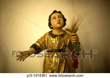 A sculpture of a boy holding a bunch of grapes is displayedin the museum of the Santa maria de la Asuncion church in Carmona, Seville province, Andalusia, Spain, April 19, 2011 View Large Photo Image Stock Image - A sculpture of a boy holding a bunch of grapes is displayedin the museum of the Santa maria de la Asuncion church in Carmona, Seville province, Andalusia, Spain, April 19, 2011. Fotosearch