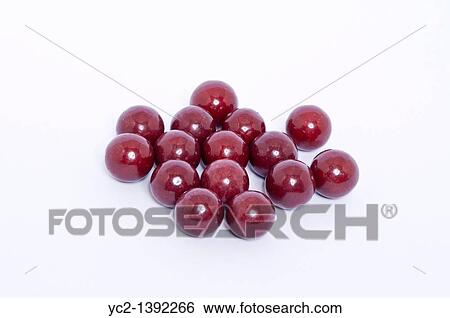 Stock Photograph - A selection of aniseed balls traditional sweets on a white background. Fotosearch