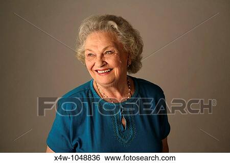 A senior citizen woman poses for a portrait View Large Photo Image Stock Photograph - A senior citizen woman poses for a portrait. Fotosearch
