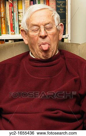 A senior elderly man in his 80's pulling a funny face at home in England, Britain, Uk View Large Photo Image Stock Photograph - A senior elderly man in his 80's pulling a funny face at home in England, Britain, Uk. Fotosearch
