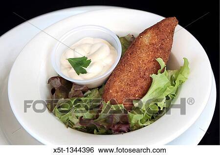 A serving of Kibbeh also kubbeh with Tehina and salad Kibbeh is meat and spices wrapped in bulgur and deep fried View Large Photo Image Stock Photograph - A serving of Kibbeh also kubbeh with Tehina and salad Kibbeh is meat and spices wrapped in bulgur and deep fried. Fotosearch
