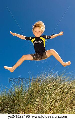 A seven year old boy playing in the sand dunes at Wells-next-the-sea, Norfolk, England, Britain, Uk View Large Photo Image Stock Photography - A seven year old boy playing in the sand dunes at Wells-next-the-sea, Norfolk, England, Britain, Uk. Fotosearch
