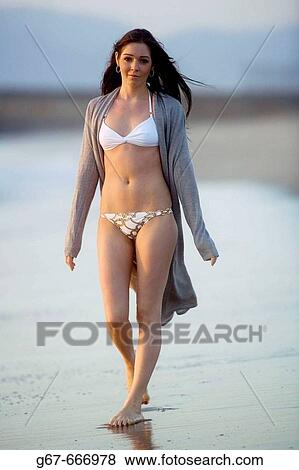 A sexy young early 20's caucasian woman wlks the beach and reflects the warm glow off the sun at dusk in Los Angeles, California, USA View Large Photo Image Stock Photo - A sexy young early 20's caucasian woman wlks the beach and reflects the warm glow off the sun at dusk in Los Angeles, California, USA. Fotosearch
