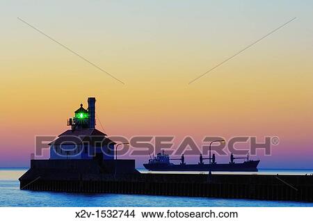 A ship awaits entry into Duluth Harbor outside of the canal breakwater at dawn in Duluth, Minnesota View Large Photo Image Picture - A ship awaits entry into Duluth Harbor outside of the canal breakwater at dawn in Duluth, Minnesota. Fotosearch