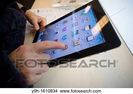 A shopper tries out an Apple iPad 2 in a Best Buy in New York over the Black Friday weekend View Large Photo Image Picture - A shopper tries out an Apple iPad 2 in a Best Buy in New York over the Black Friday weekend. Fotosearch