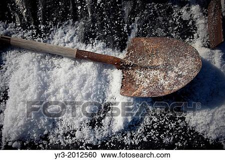 Stock Image - A shovel lays on top of salt at the Salinas de Hortales salt mine in Prado del Rey, Cadiz, Andalusia, Spain. Fotosearch