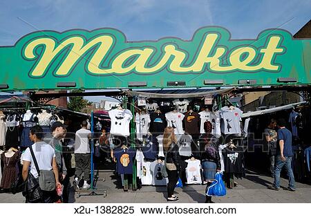 Stock Photography - A sign reading? Market? above a clothes market. Fotosearch