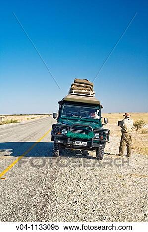A single car on a tar road in Botswana, Africa View Large Photo Image Stock Photography - A single car on a tar road in Botswana, Africa. Fotosearch