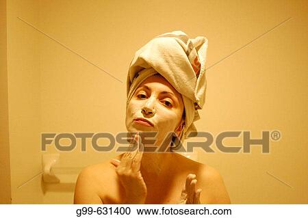 A single woman of a certain age prepares for an evening out in a large Canadian city during the middle of the winter. View Large Photo Image Stock Image - A single woman of a certain age prepares for an evening out in a large Canadian city during the middle of the winter.. Fotosearch