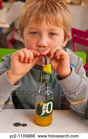 A six year old boy drinking a J2o juice drink in England, Britain, Uk View Large Photo Image Stock Photograph - A six year old boy drinking a J2o juice drink in England, Britain, Uk. Fotosearch