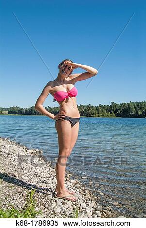 A sixteen year old girl in a bikini stands by a lake in southern Alberta, Canada View Large Photo Image Stock Photography - A sixteen year old girl in a bikini stands by a lake in southern Alberta, Canada. Fotosearch