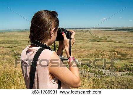 A sixteen year old girl takes photos at Head Smashed In Buffalo Jump in southern Alberta, Canada View Large Photo Image Stock Image - A sixteen year old girl takes photos at Head Smashed In Buffalo Jump in southern Alberta, Canada. Fotosearch