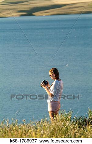 A sixteen year old girl takes photos near a lake in southern Alberta, Canada View Large Photo Image Stock Photo - A sixteen year old girl takes photos near a lake in southern Alberta, Canada. Fotosearch