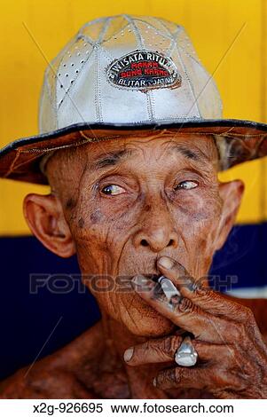 A skinny elderly man smoking cigarette, Semarang, Central Java, Indonesia View Large Photo Image Stock Photography - A skinny elderly man smoking cigarette, Semarang, Central Java, Indonesia. Fotosearch