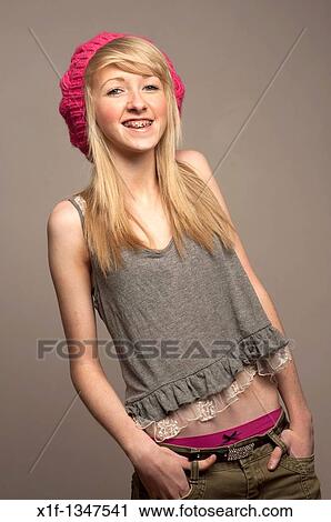 A slim blonde 14 year old teenage girl with dental braces on her teeth