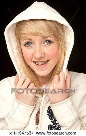 Stock Photo - A slim blonde 14 year old teenage girl with dental braces on her teeth, UK. Fotosearch