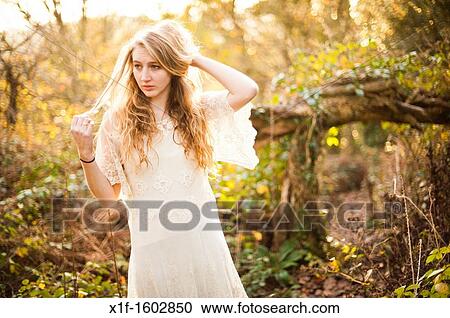 a slim blonde woman girl alone in woodland autumn afternoon daytime UK View Large Photo Image Stock Image - a slim blonde woman girl alone in woodland autumn afternoon daytime UK. Fotosearch