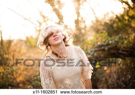 a slim blonde woman girl alone in woodland autumn afternoon daytime UK View Large Photo Image Stock Image - a slim blonde woman girl alone in woodland autumn afternoon daytime UK. Fotosearch