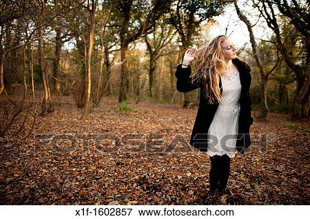 a slim blonde woman girl alone in woodland autumn afternoon daytime UK View Large Photo Image Stock Photo - a slim blonde woman girl alone in woodland autumn afternoon daytime UK. Fotosearch