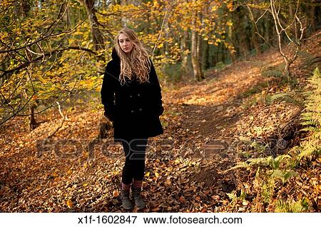 a slim pensive blonde woman girl alone in woodland autumn afternoon daytime UK View Large Photo Image Stock Photo - a slim pensive blonde woman girl alone in woodland autumn afternoon daytime UK. Fotosearch
