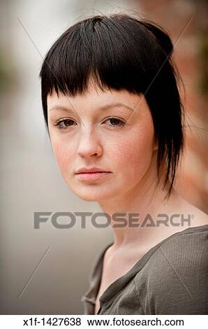 Stock Photo - a slim teenage 18, 19, 20 years old girl with short dark hair. Fotosearch