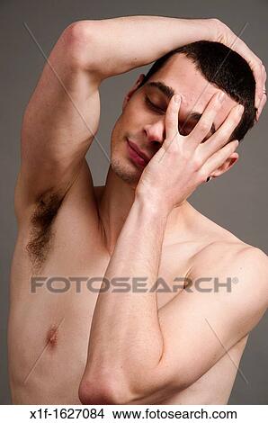A slim thin slender late teen boy young man adult holding his head in his hands, hungover ill sick View Large Photo Image Picture - A slim thin slender late teen boy young man adult holding his head in his hands, hungover ill sick. Fotosearch