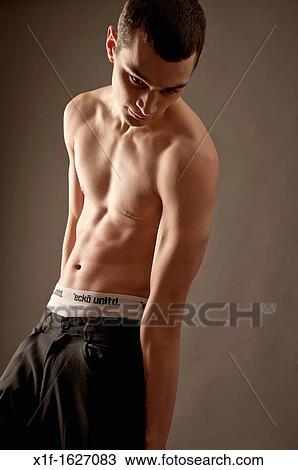 A slim thin slender late teen boy young man adult, looking sensitive, UK View Large Photo Image Stock Image - A slim thin slender late teen boy young man adult, looking sensitive, UK. Fotosearch
