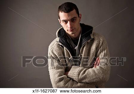 A slim thin slender late teen boy young man adult, with his arms folded UK View Large Photo Image Stock Photo - A slim thin slender late teen boy young man adult, with his arms folded UK. Fotosearch