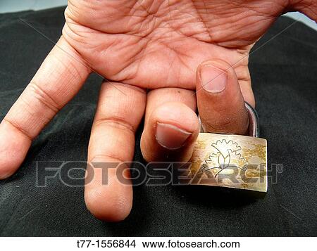 Picture - A small Padlock in Human Hand. Fotosearch