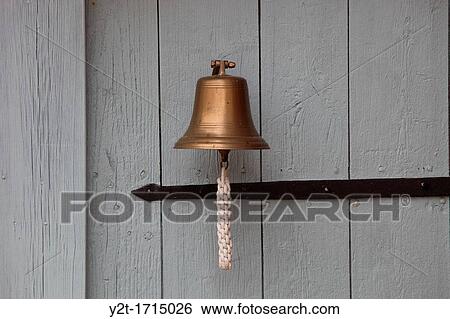 A small ship's bell hanging on a white wooden door View Large Photo Image Stock Photograph - A small ship's bell hanging on a white wooden door. Fotosearch