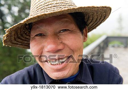 Stock Image - A smiling Chinese man at the San Huang Zhai Monastery on the Song Mountain, China. Fotosearch