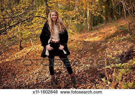 a smiling happy slim blonde woman girl alone in woodland autumn afternoon daytime UK View Large Photo Image Stock Photo - a smiling happy slim blonde woman girl alone in woodland autumn afternoon daytime UK. Fotosearch