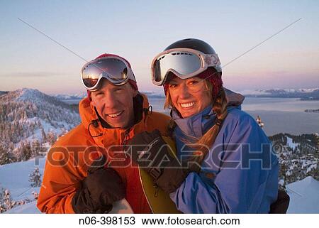 A snowboarding couple stands on the summit of Diamond Peak Ski Resort. Nevada. USA View Large Photo Image Stock Image - A snowboarding couple stands on the summit of Diamond Peak Ski Resort. Nevada. USA. Fotosearch