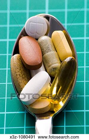 Stock Image - A spoonful of vitamin supplements. Fotosearch