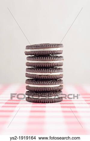 A stack of five chocolate cookies with vanilla cream filling View Large Photo Image Picture - A stack of five chocolate cookies with vanilla cream filling. Fotosearch