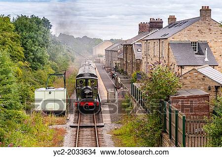 A steam train engine arrives at the Leyburn Station on the Wensleydale Railway in Leyburn, North Yorkshire, England, Britain, Uk. View Large Photo Image Picture - A steam train engine arrives at the Leyburn Station on the Wensleydale Railway in Leyburn, North Yorkshire, England, Britain, Uk.. Fotosearch
