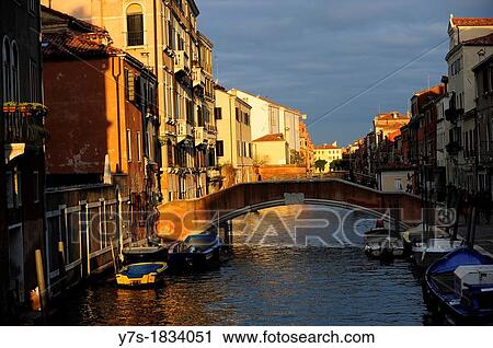 Stock Image - A street in Venice with canal and bridge, Italy, Europe. Fotosearch