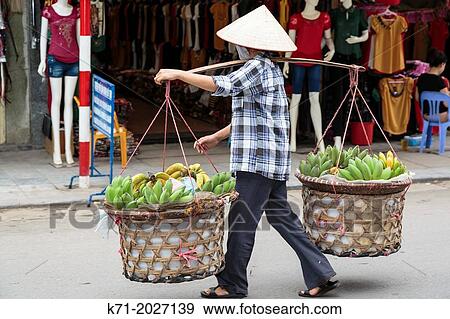 Stock Photo - A street vendor selling fresh produce in Hanoi, Vietnam, Asia.. Fotosearch