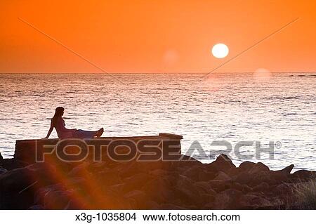 A stunning sunset at the secluded Pakala's beach, Hawaii View Large Photo Image Picture - A stunning sunset at the secluded Pakala's beach, Hawaii. Fotosearch