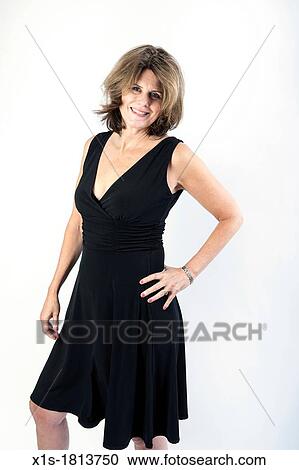 A stylish american woman wearing a black dress poses with her left hand on hip View Large Photo Image Stock Image - A stylish american woman wearing a black dress poses with her left hand on hip. Fotosearch