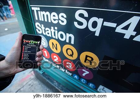 A subway rider checks the new MTA Subway Time app outside the Times Square station in New York View Large Photo Image Stock Photo - A subway rider checks the new MTA Subway Time app outside the Times Square station in New York. Fotosearch