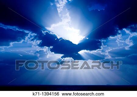 A sunburst through the clouds near Muscat, Oman View Large Photo Image Stock Photograph - A sunburst through the clouds near Muscat, Oman. Fotosearch